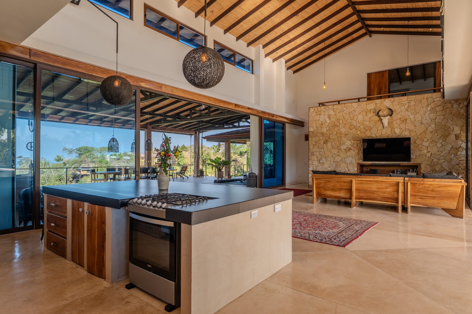 The full chef's kitchen with stone wall