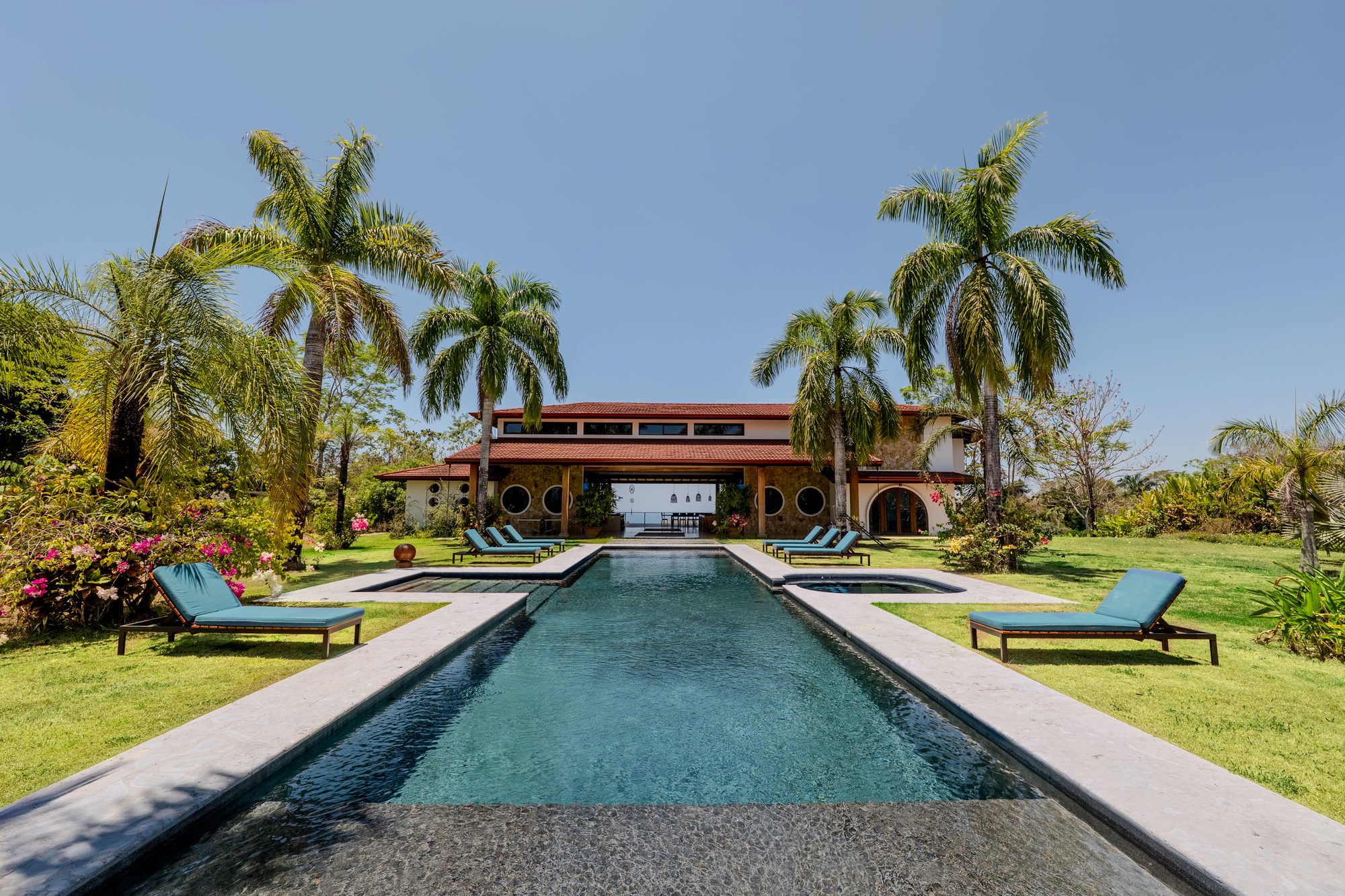 The saltwater pool and tropical gardens by day