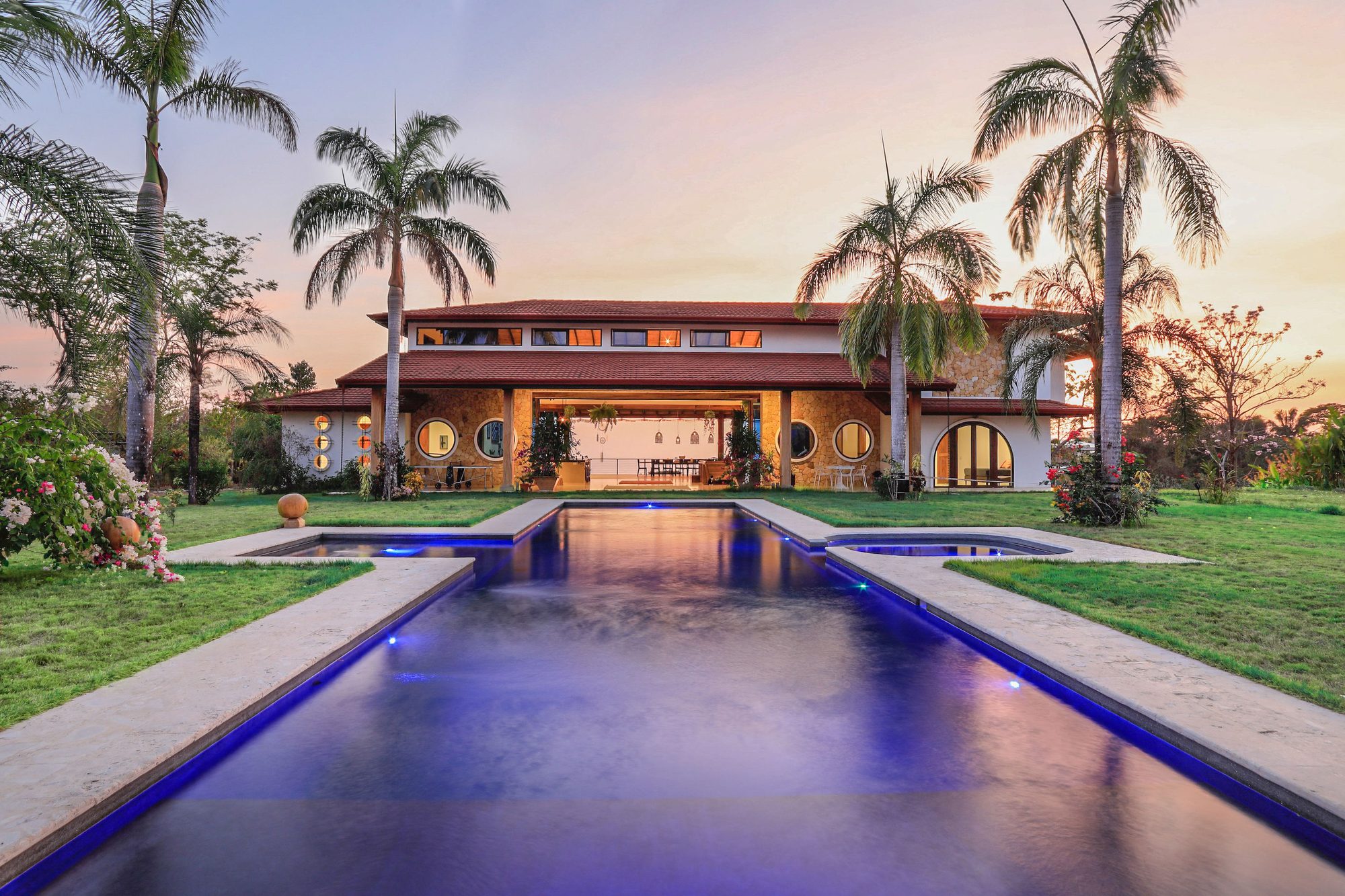 The 18-metre saltwater pool glowing at twilight, facing Tanit Villa
