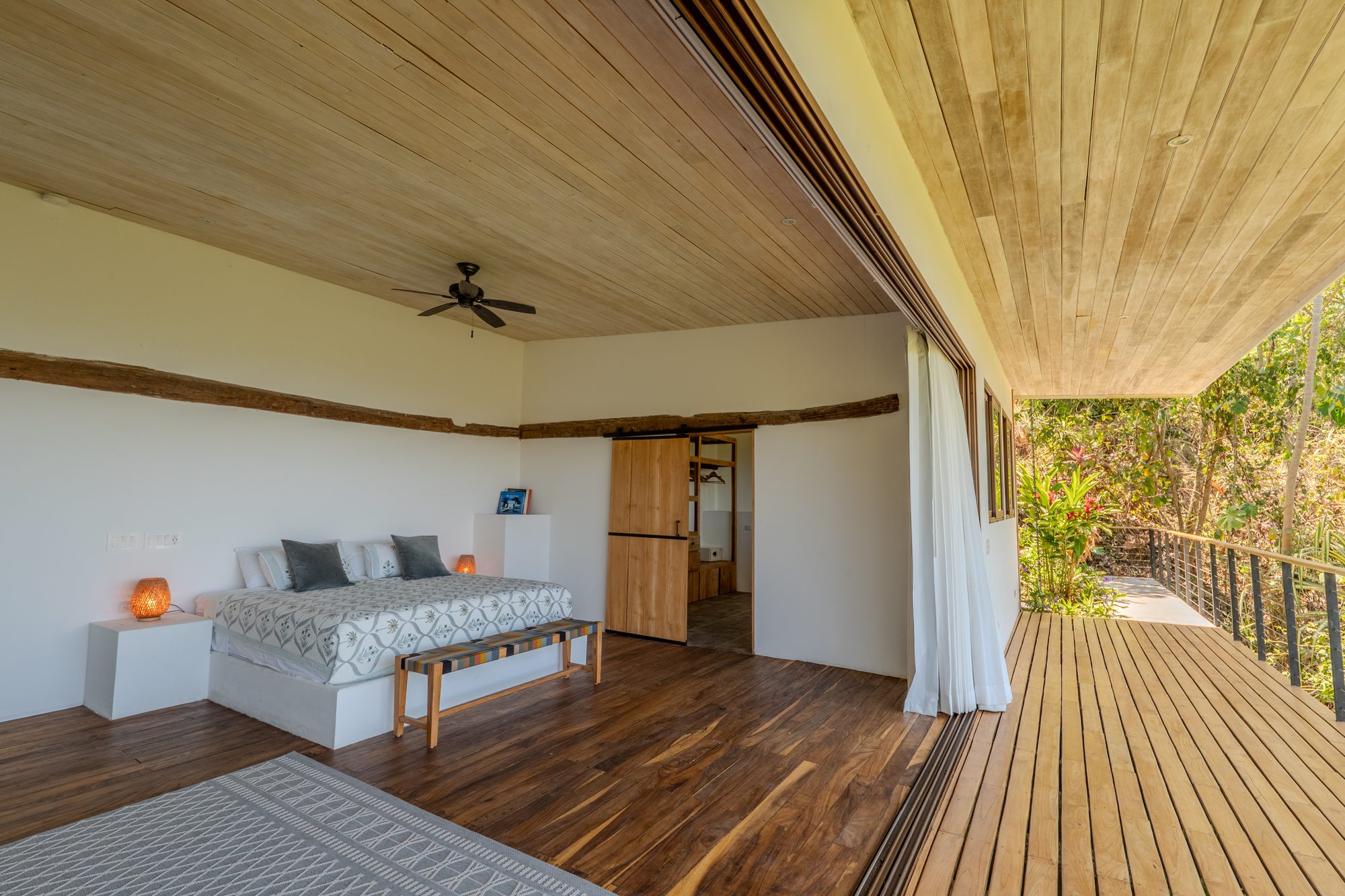 Guest suite opening onto a private deck and jungle