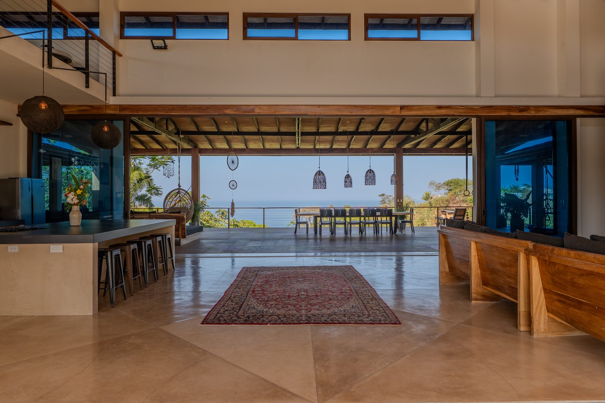 The open-plan great room opening to the terrace and ocean